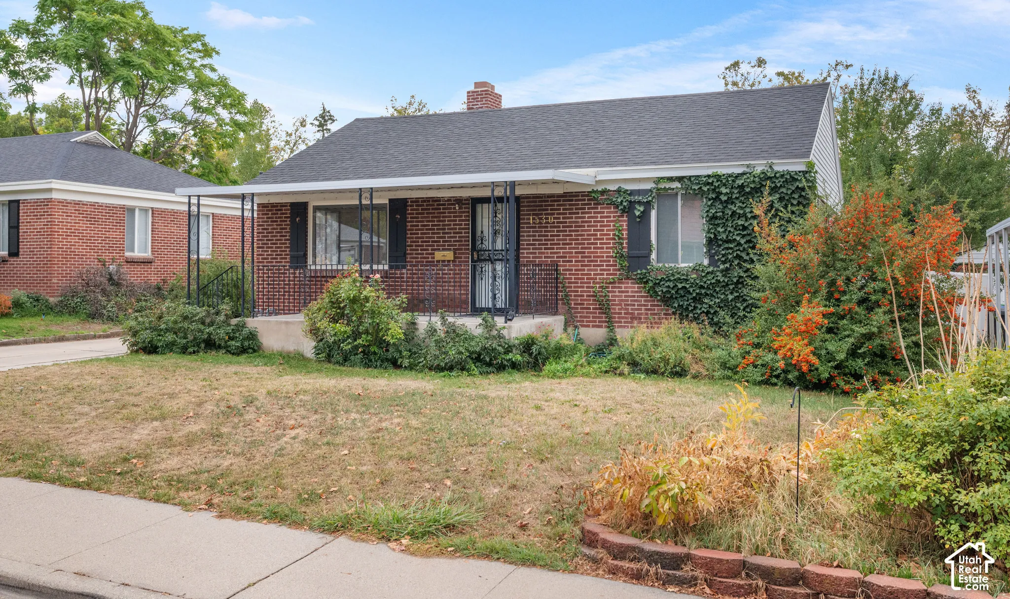 Classic brick ranch home featuring a welcoming front fa
