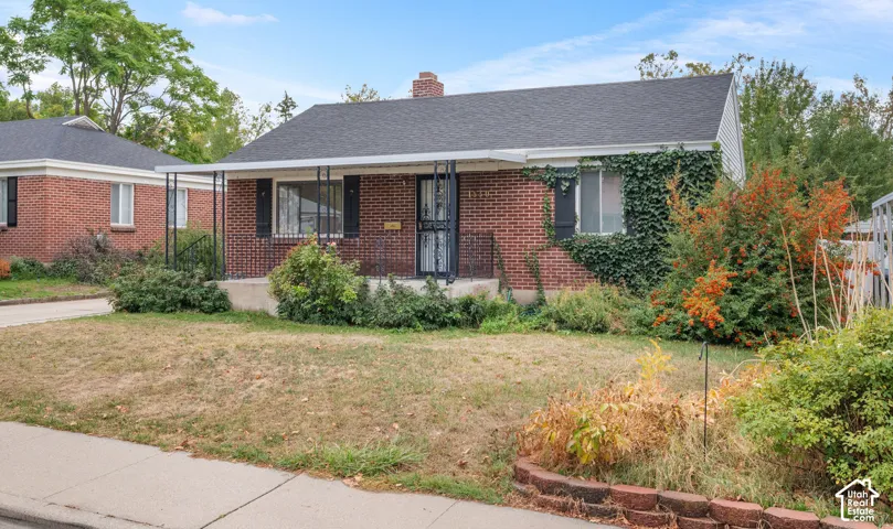 Classic brick ranch home featuring a welcoming front fa