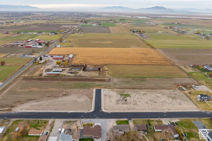 Newly paved street, cul-de-sac, adjacent agricultural fields, and distant mountain range