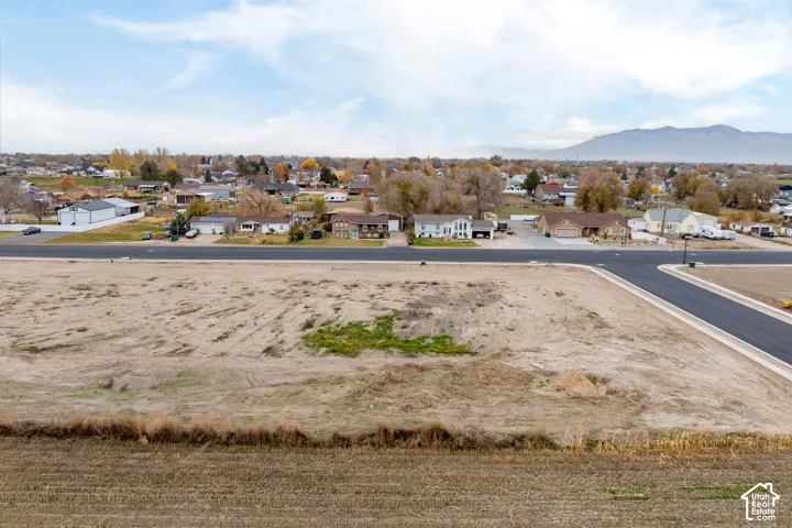 Expansive undeveloped lot featuring a newly paved street and curb