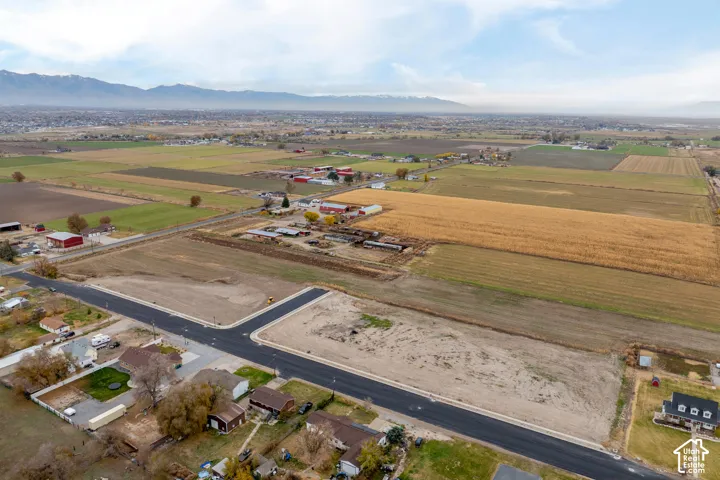 Expansive undeveloped land featuring paved roads, a cul-de-sac, and distant mountain backdrops