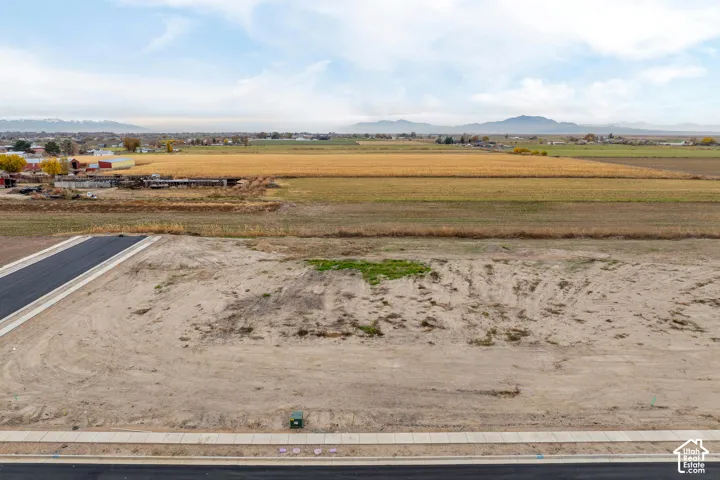 Level lot with paved road access and an adjacent sidewalk