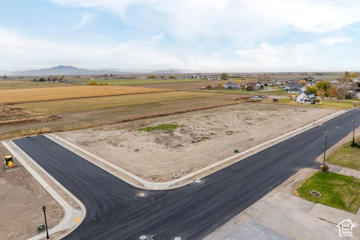 Expansive corner lot with established street infrastructure, including paved roads and integrated sidewalks