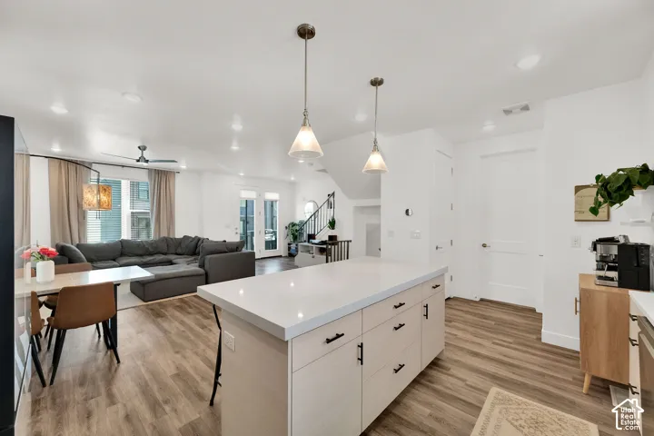 Spacious kitchen island with a light-toned wood finish and ample storage