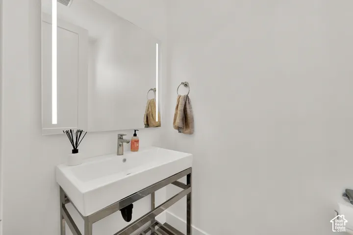 Rectangular vessel sink with a single-handle faucet, set on a metal-frame vanity