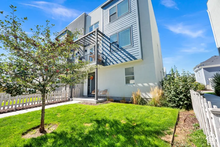 Modern exterior with horizontal siding and a white picket fence