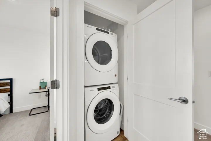 Dedicated laundry closet with stacked white washer and dryer
