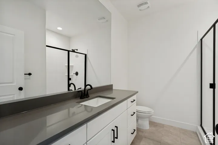 White vanity with matte black hardware, integrated sink, and gray countertop
