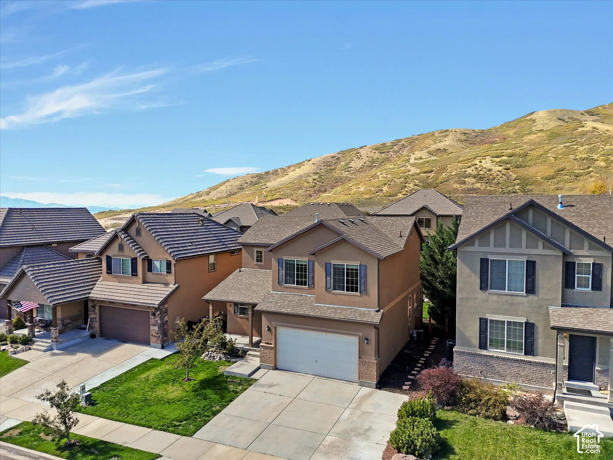Neighborhood setting with mountain backdrop and residential homes
