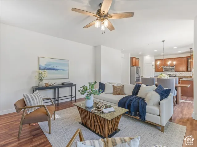 Wood-finish flooring throughout, ceiling fan with integrated lighting, and an open concept layout