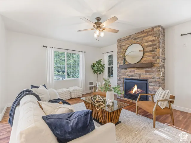 Stacked stone fireplace with a wood mantel