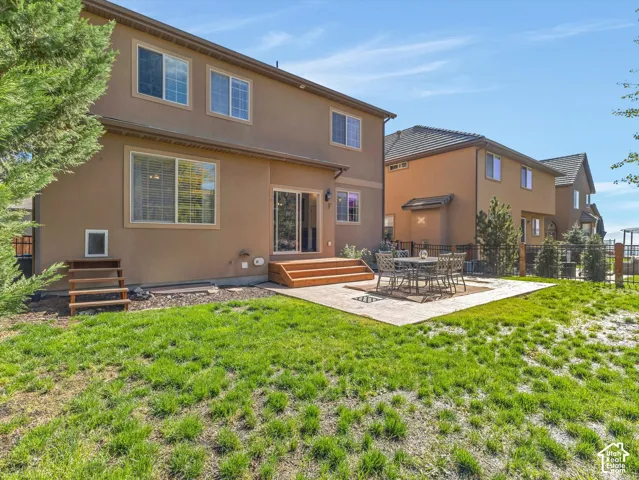 Stunning two-story residence with warm-toned stucco exterior and multi-pane windows