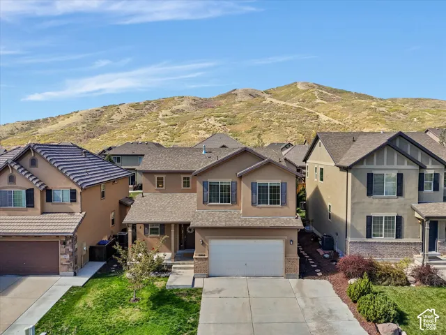 Two-story residence with a two-car garage and a paved driveway