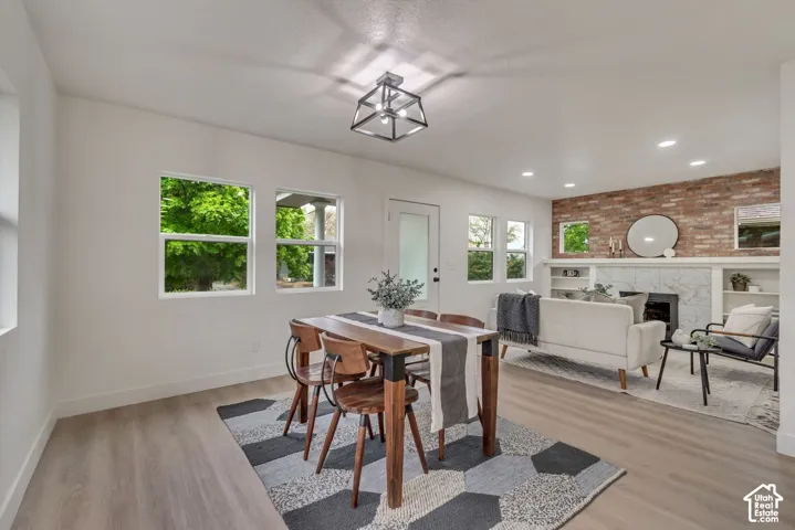 Wood-finish flooring throughout, white walls, and recessed lighting