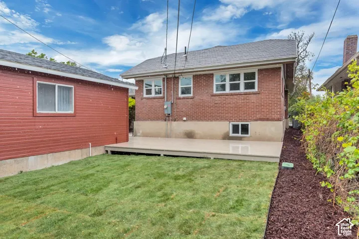 Brick exterior with multiple windows, leading to an expansive deck