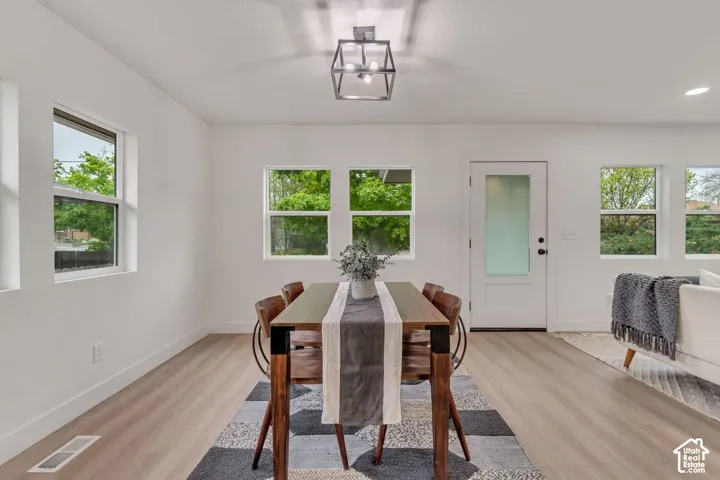 Wood-finish flooring throughout, multiple pane windows, and a frosted glass panel door