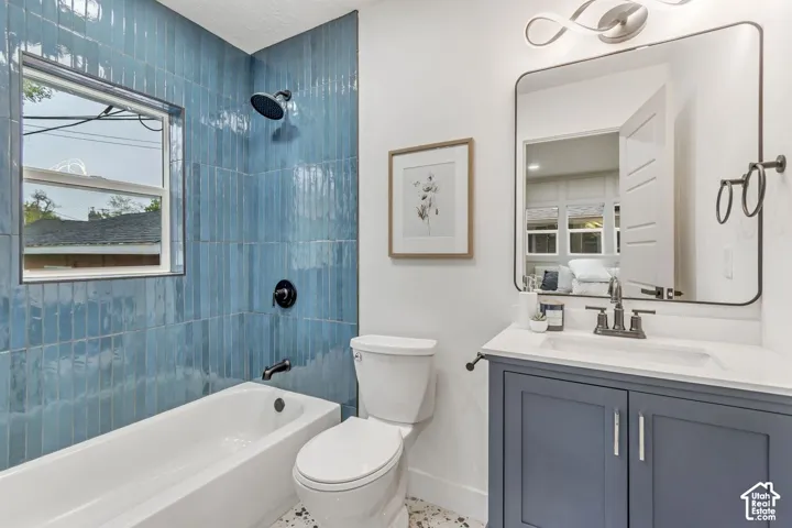 White bathtub with blue subway tile surround