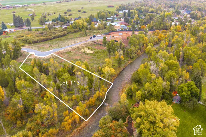 Riverfront lot with abundant mature trees and paved road access