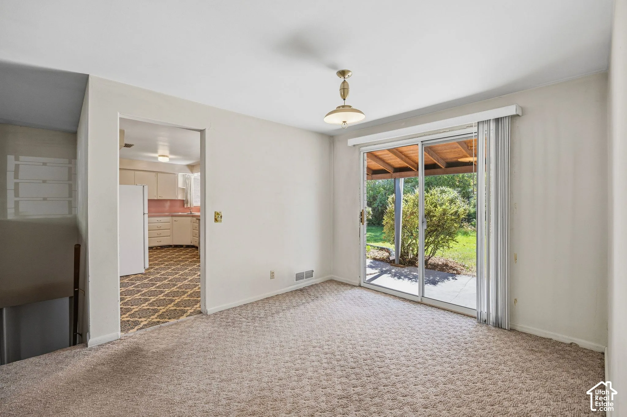 Dining area with a sliding glass door to a covered outdoor patio