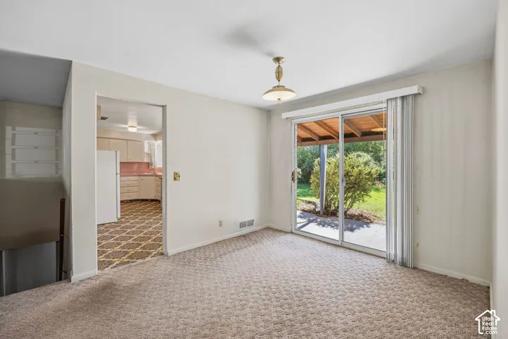 Dining area with a sliding glass door to a covered outdoor patio