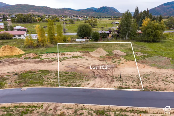 Graded lot with an asphalt road frontage and mountain backdrop