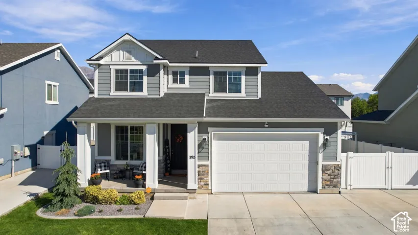 Contemporary exterior with gray siding, white trim, and a covered front porch
