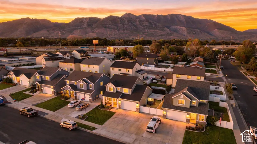 Residential neighborhood featuring varied architectural styles, paved streets, and manicured lawns