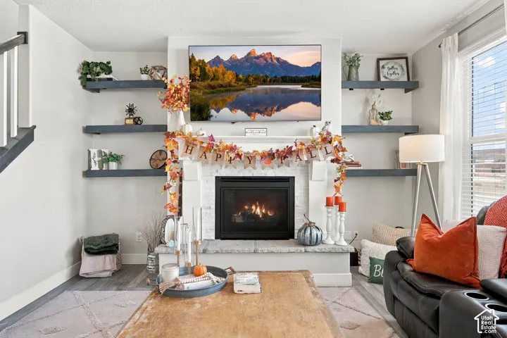 White-painted fireplace with a black firebox, stone hearth, and mantel