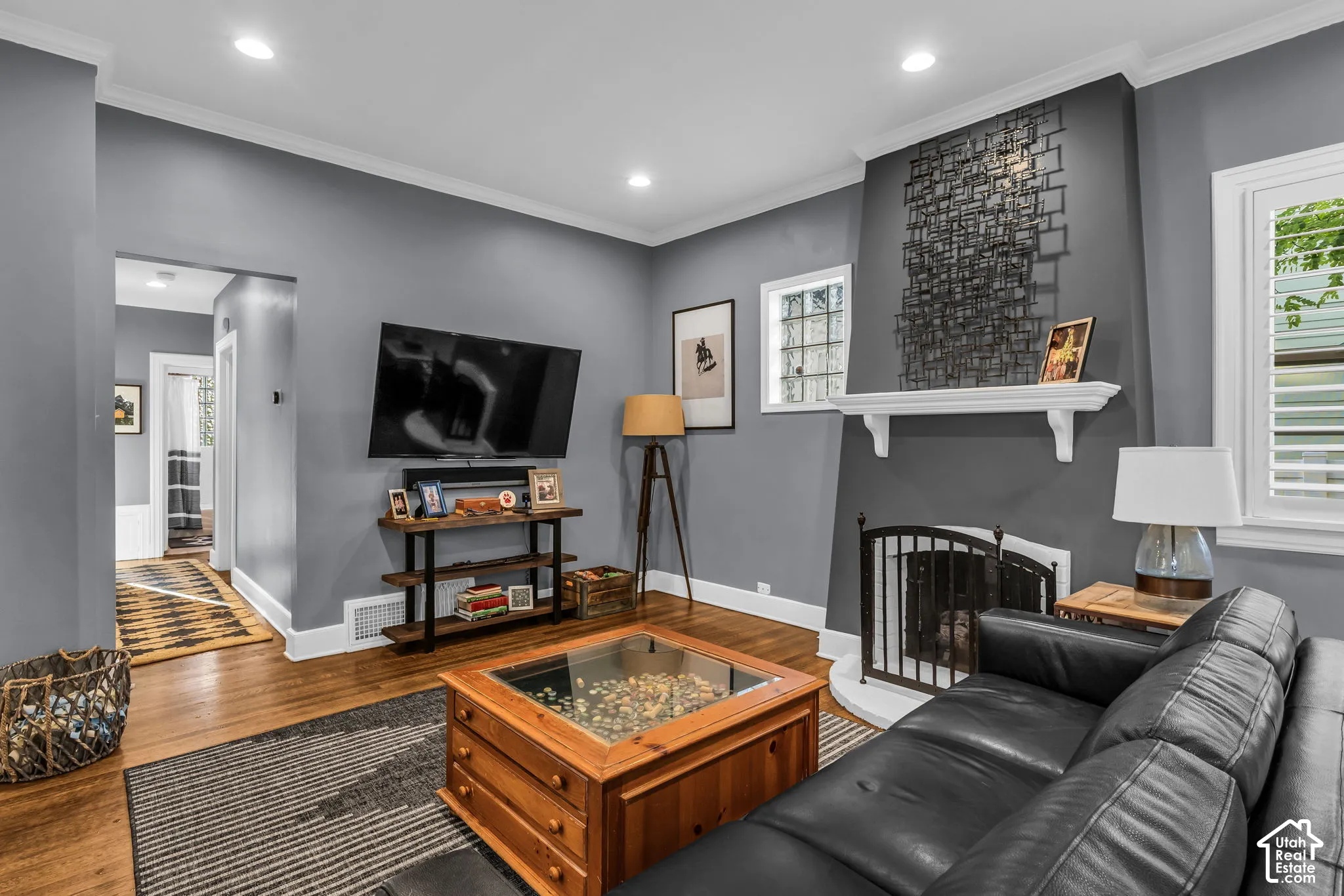 Wood-finish flooring, recessed lighting, and crown molding