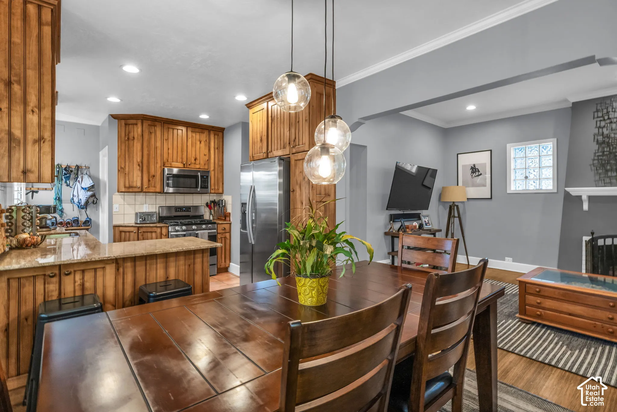 Kitchen with wood-finish cabinetry, stainless steel appliances, and light-toned countertops