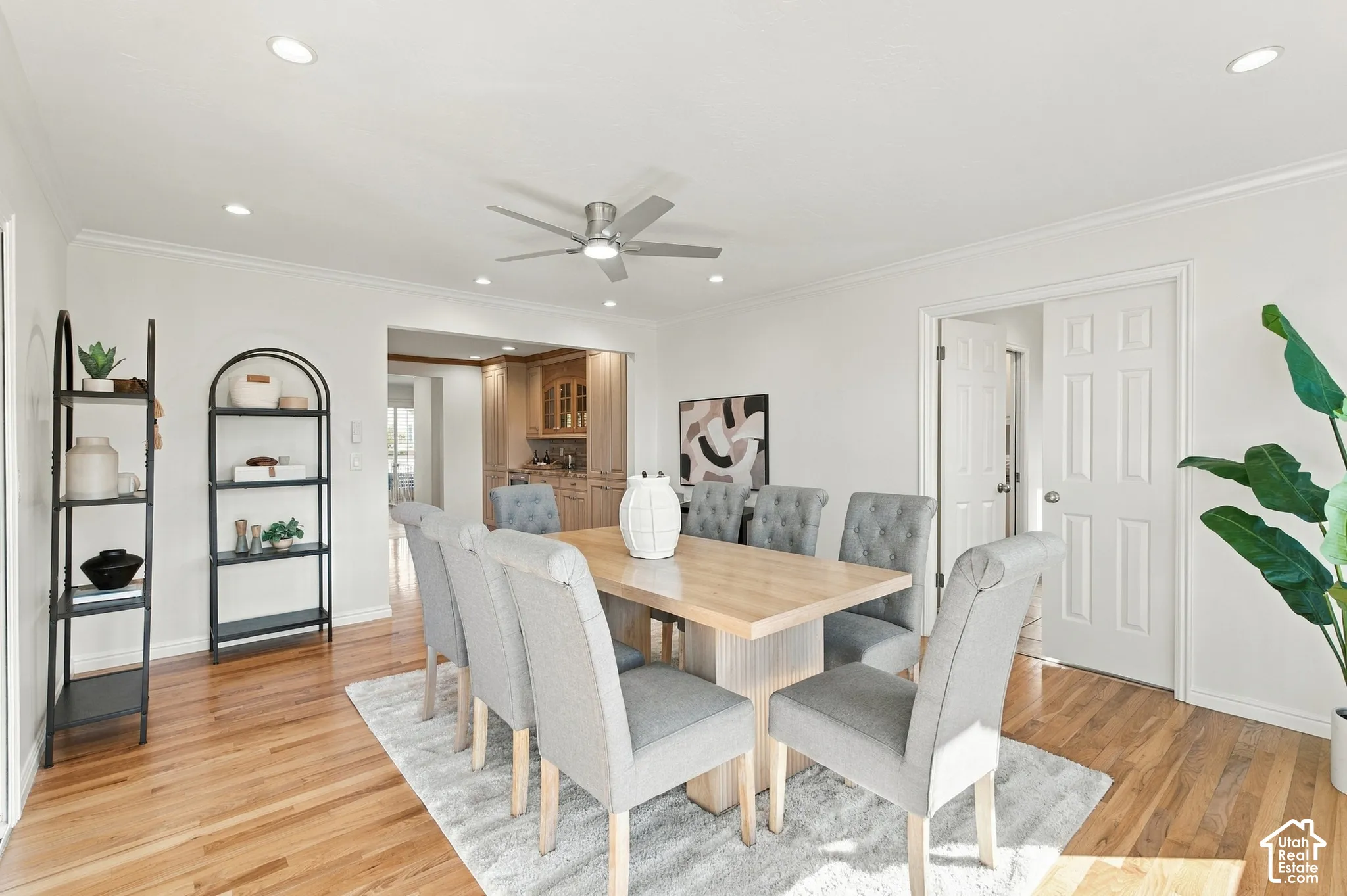 Hardwood flooring, recessed lighting, crown molding, ceiling fan, and white panel doors