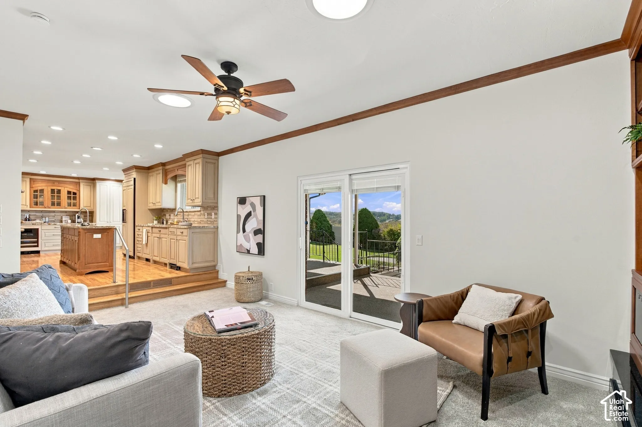 Recessed lighting, wood-finish ceiling fan, and crown molding