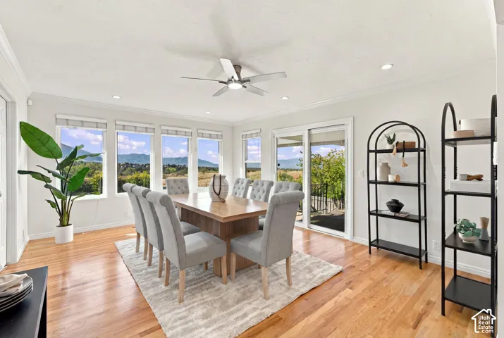 Hardwood flooring, recessed lighting, ceiling fan, multiple windows with natural scenery, and sliding glass door