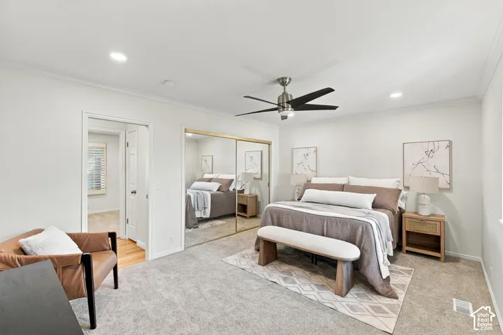 Recessed lighting, crown molding, ceiling fan, mirrored closet doors, and light-toned carpeting