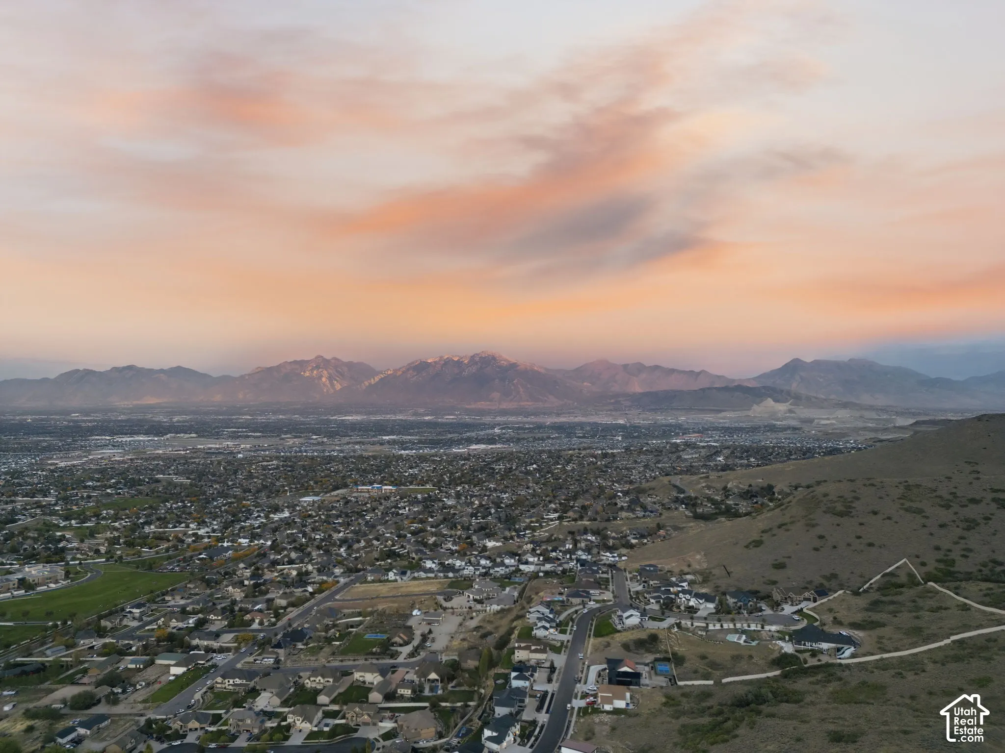 Expansive landscape with a distinct mountain range under a colorful sky