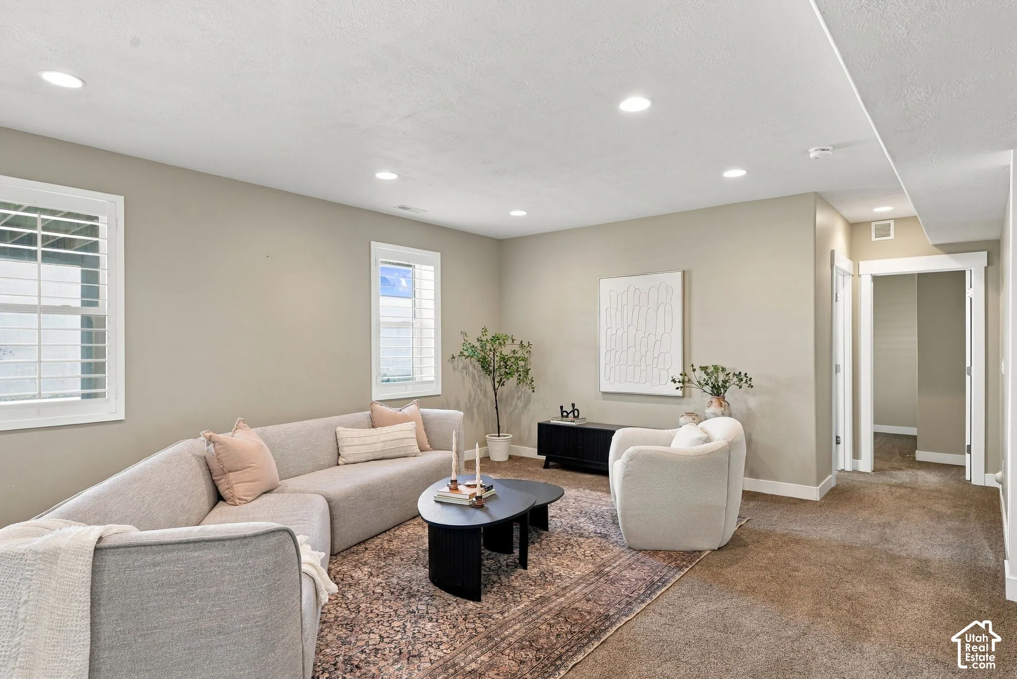 Recessed lighting illuminates the space, featuring neutral-toned walls and crisp white trim