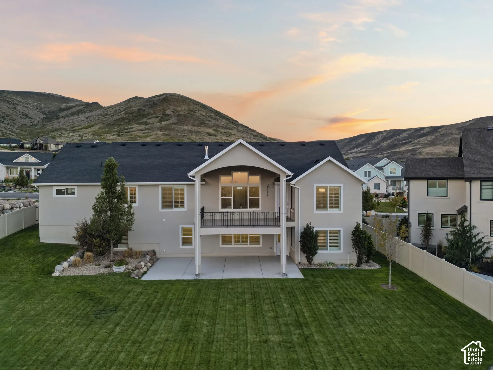 Expansive manicured lawn with a privacy fence