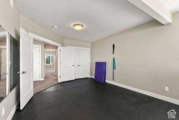 Bedroom four, recessed lighting, rubber flooring, built-in mirrored wall, and white panel doors