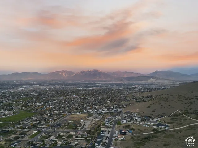 Expansive landscape with a distinct mountain range under a colorful sky