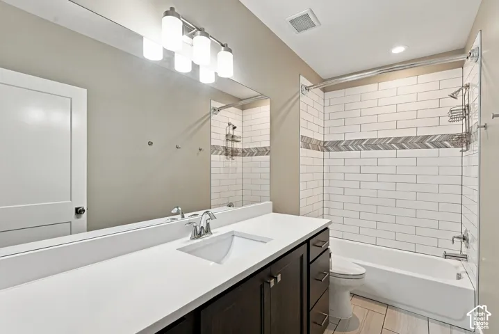 Basement bathroom three, oversized vanity with integrated sink, chrome faucet, and dark wood-finish cabinetry