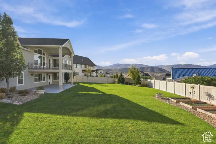 Expansive grassy yard with tiered raised garden beds