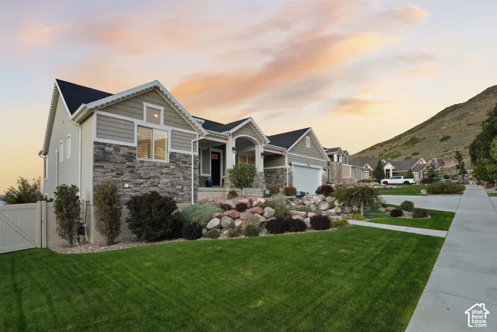 Stone and siding exterior with a covered porch.