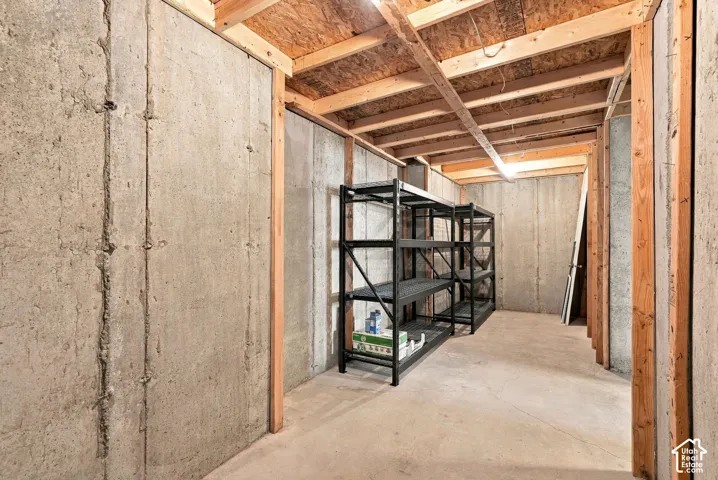 Basement cold storage, extra storage, concrete foundation walls with exposed wood framing and a concrete floor