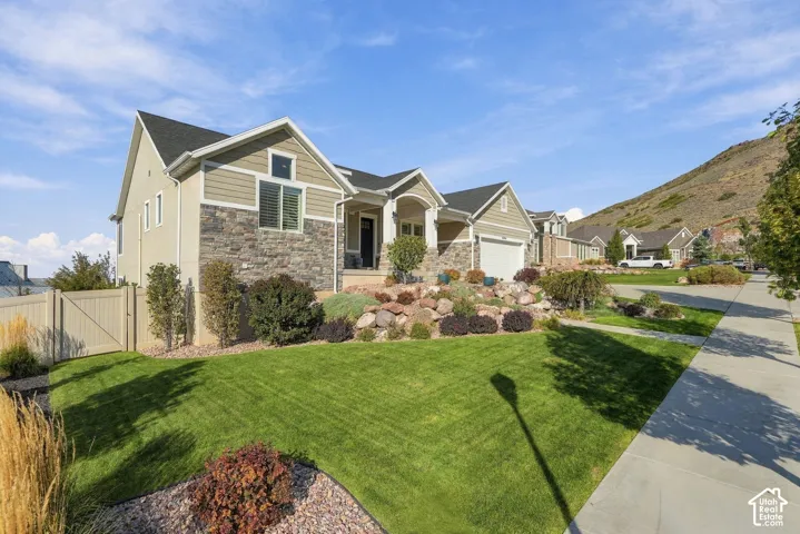 Stucco and stone exterior featuring multiple gables