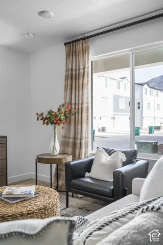 Large window with roller shade and black curtain rod
