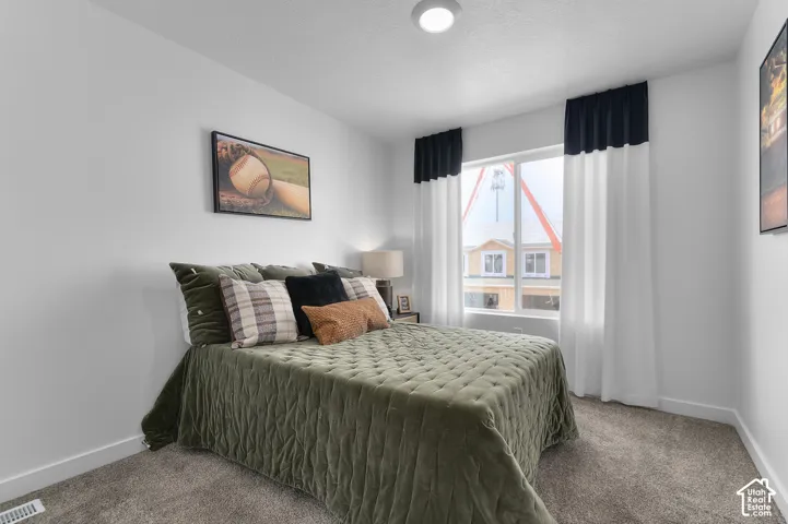 Neutral wall paint, plush carpet flooring, recessed ceiling lighting, and a large window