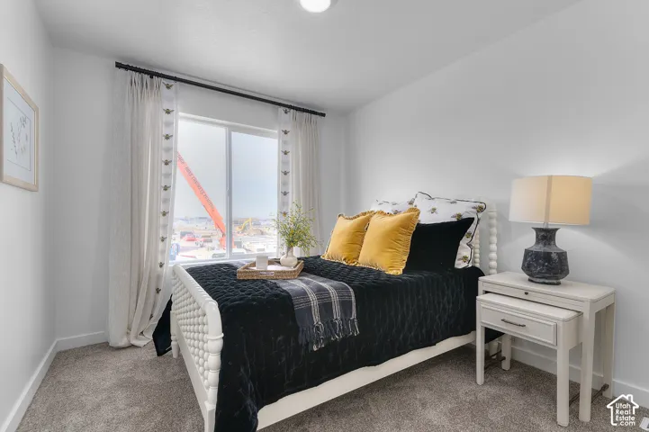 Neutral wall finishes, recessed ceiling lighting, light gray carpet, and a white window frame