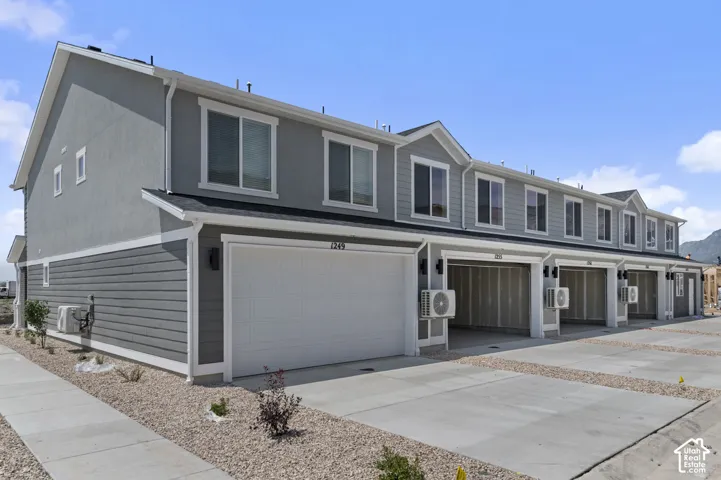 Modern townhome exterior with gray siding and stucco finishes