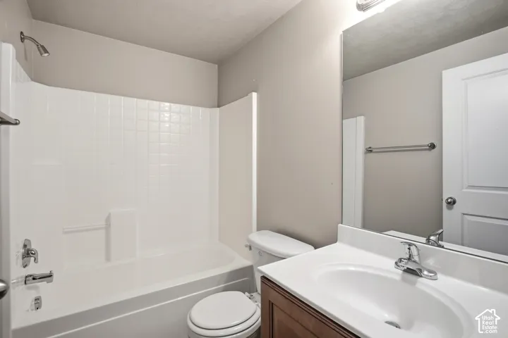 White tile-patterned shower surround with integrated tub