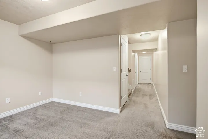 Neutral-toned walls complement the gray carpeting